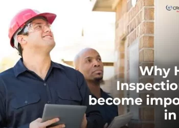 Two home inspectors examining the exterior of a brick house; one holding a tablet and wearing a red safety helmet, with text overlay reading 'Why Home Inspection has become important in India' and CREATIVE Proptech logo.