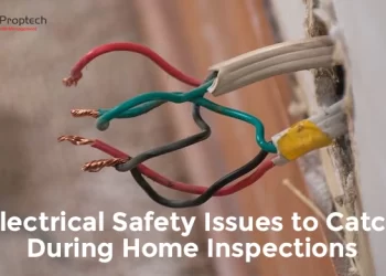 Exposed electrical wires sticking out of a wall with frayed insulation, indicating potential safety hazard; text overlay reads 'Electrical Safety Issues to Catch During Home Inspections' with CREATIVE Proptech logo.
