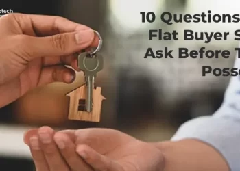 Person handing over house keys with a wooden home keychain to another person with text overlay reads 10 Questions Every Flat Buyer Should Ask Before Taking Possession with CREATIVE Proptech logo.